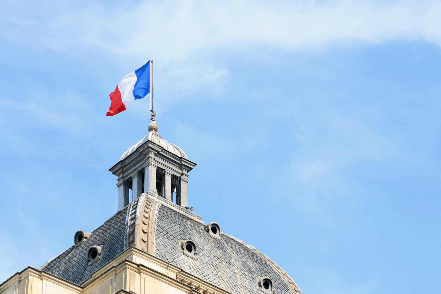 The French flag flying from a building