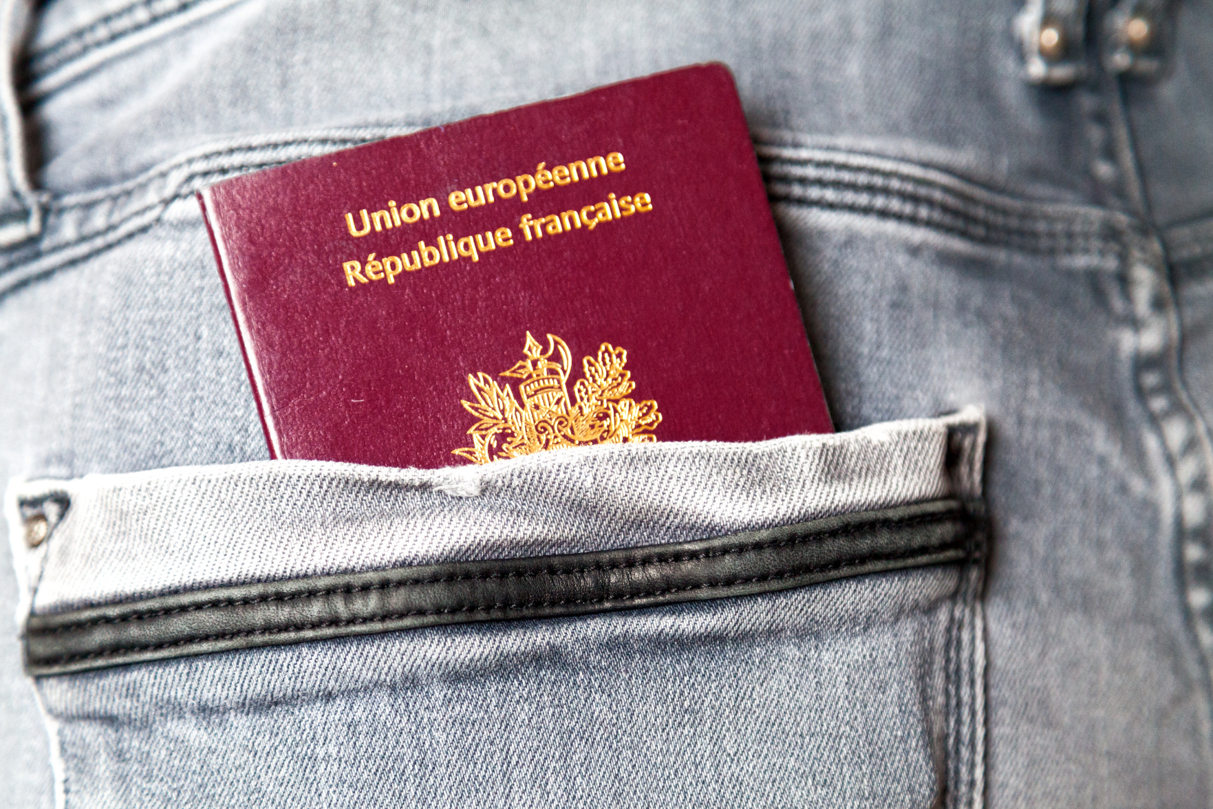 French passport in jean pocket