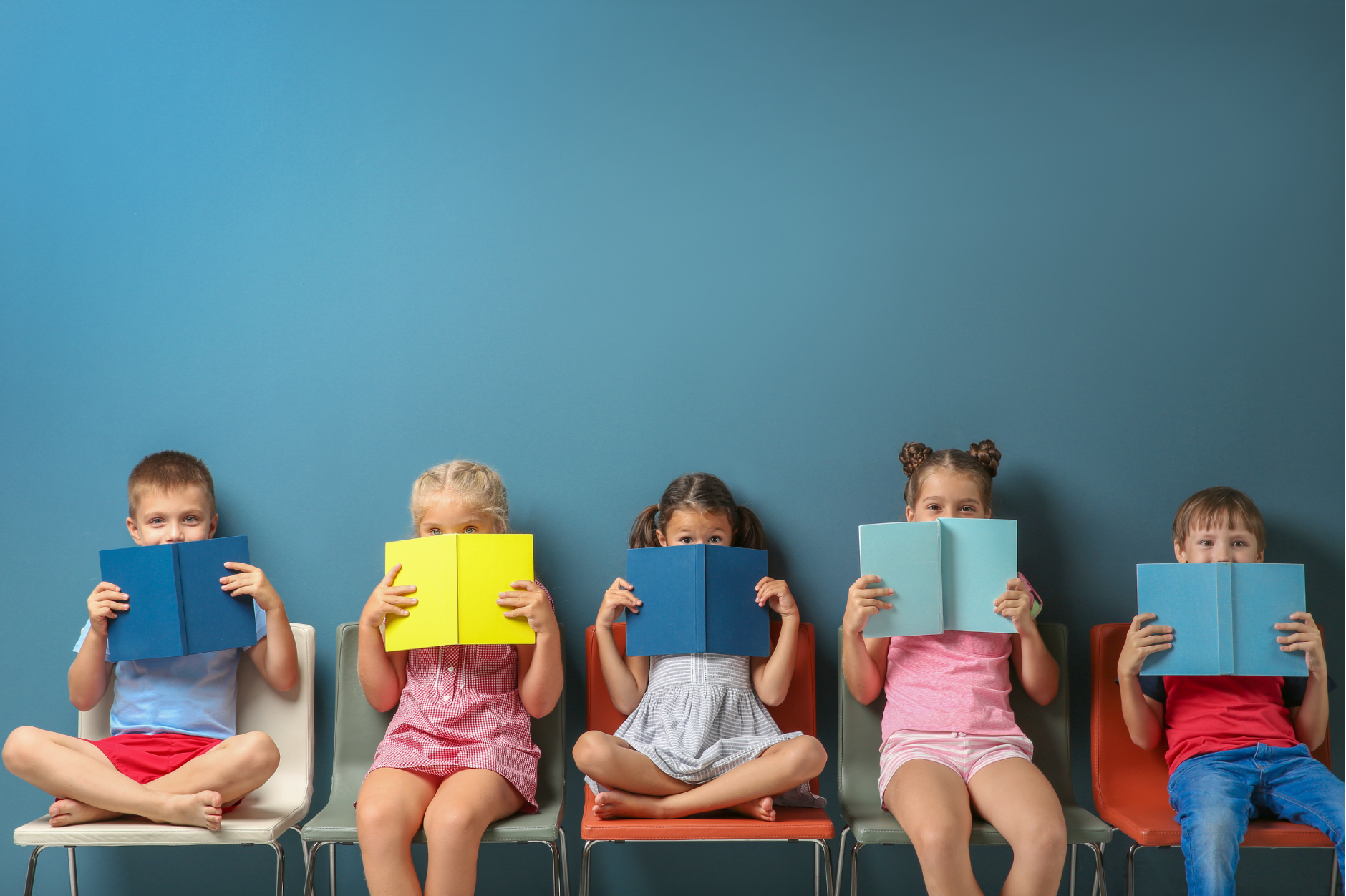Group of schoolchildren reading textbooks