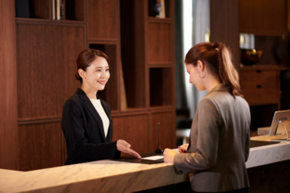 A receptionist and hotel guest