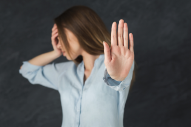 A woman making a negative hand gesture