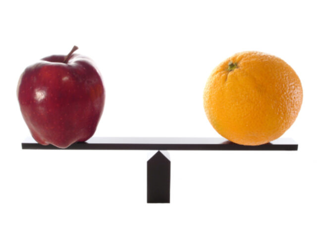 Apple and orange on a weighing scale