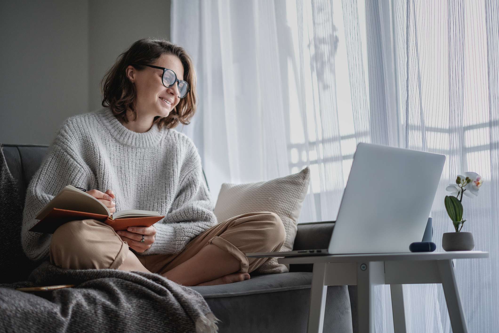 A woman sat at a laptop