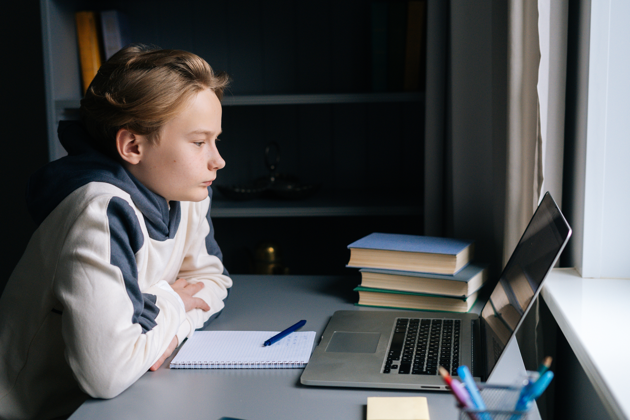 A woman learning on a laptop