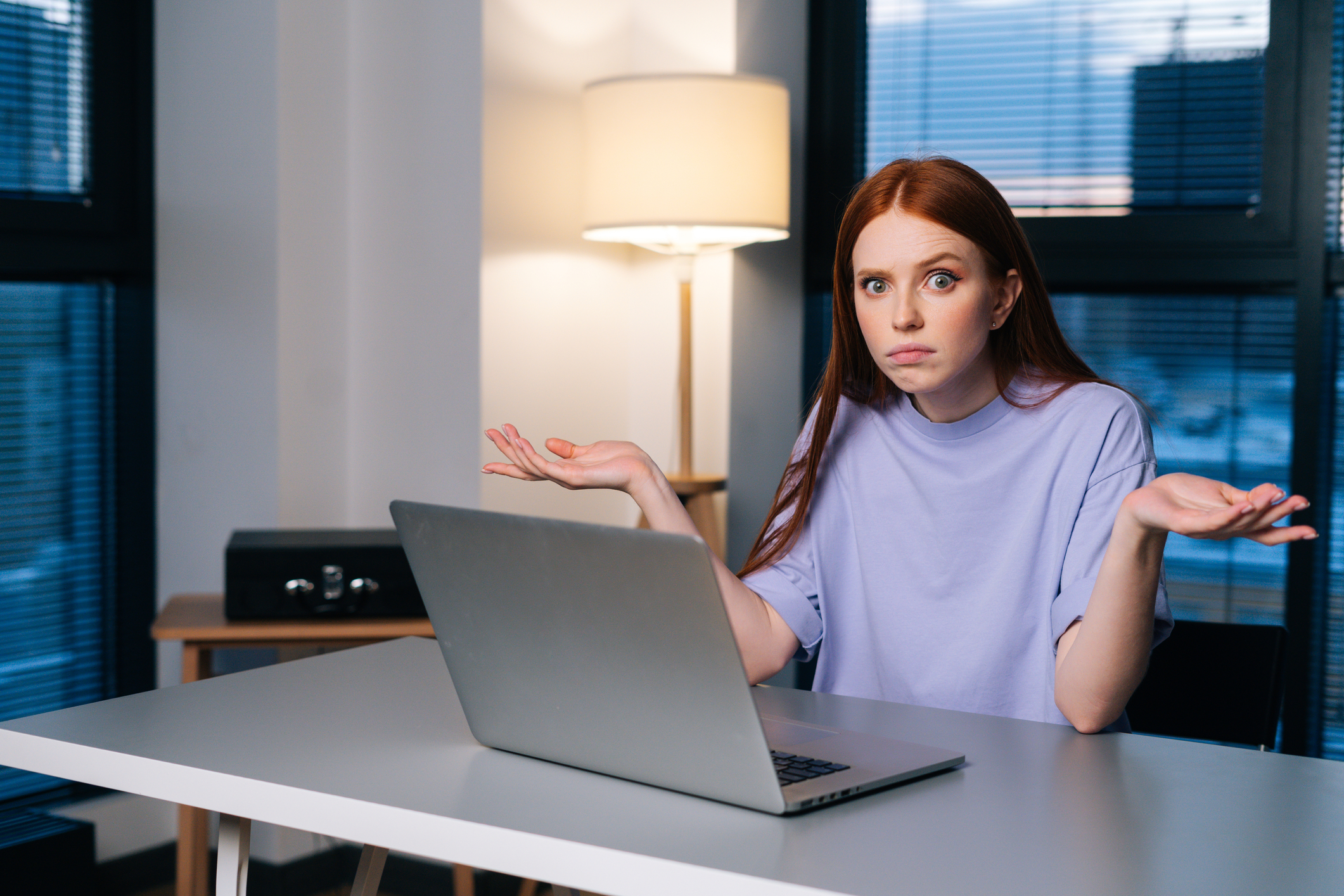 Woman behind computer looking confused