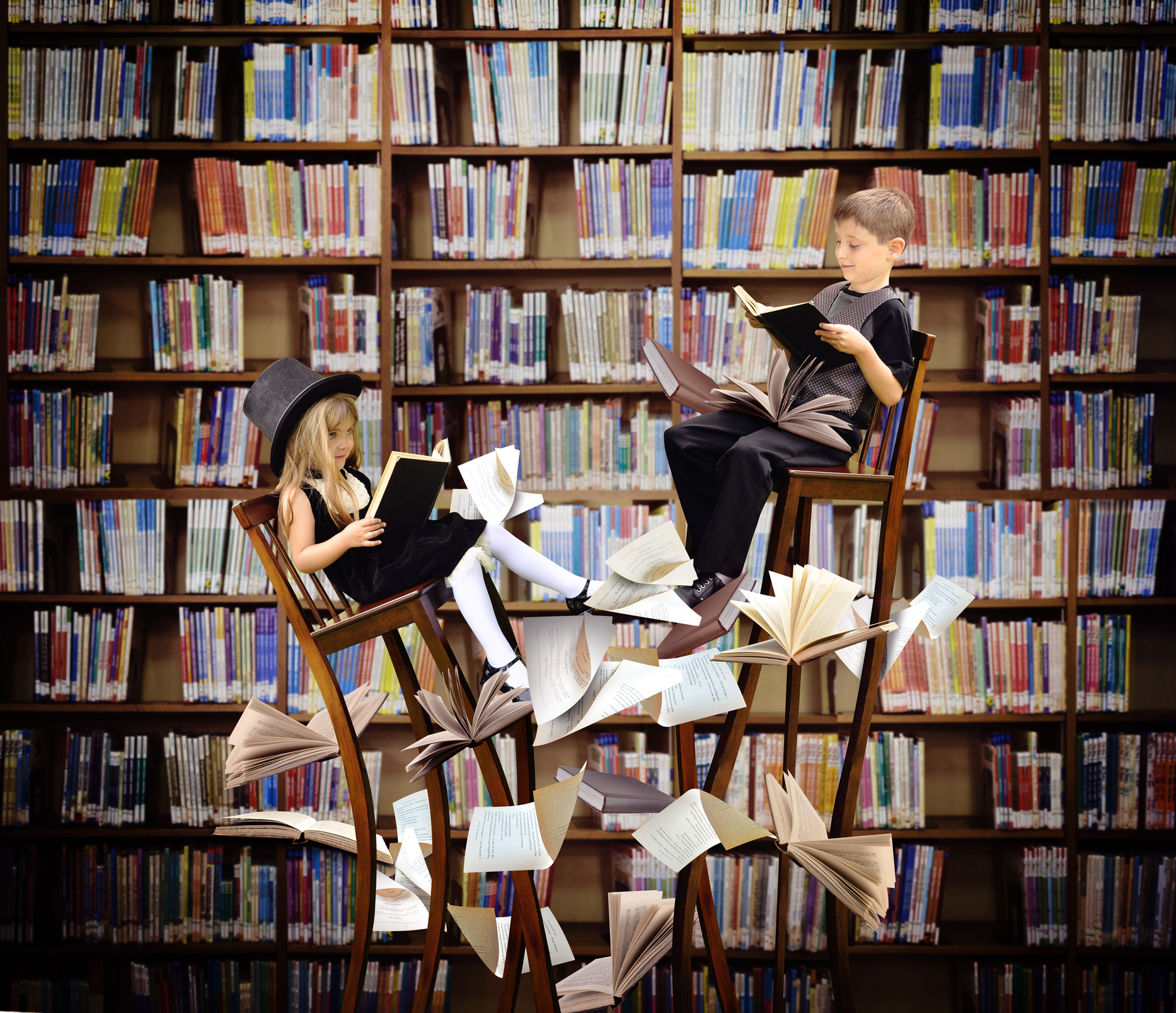 Two women sitting on stacked chairs in a library