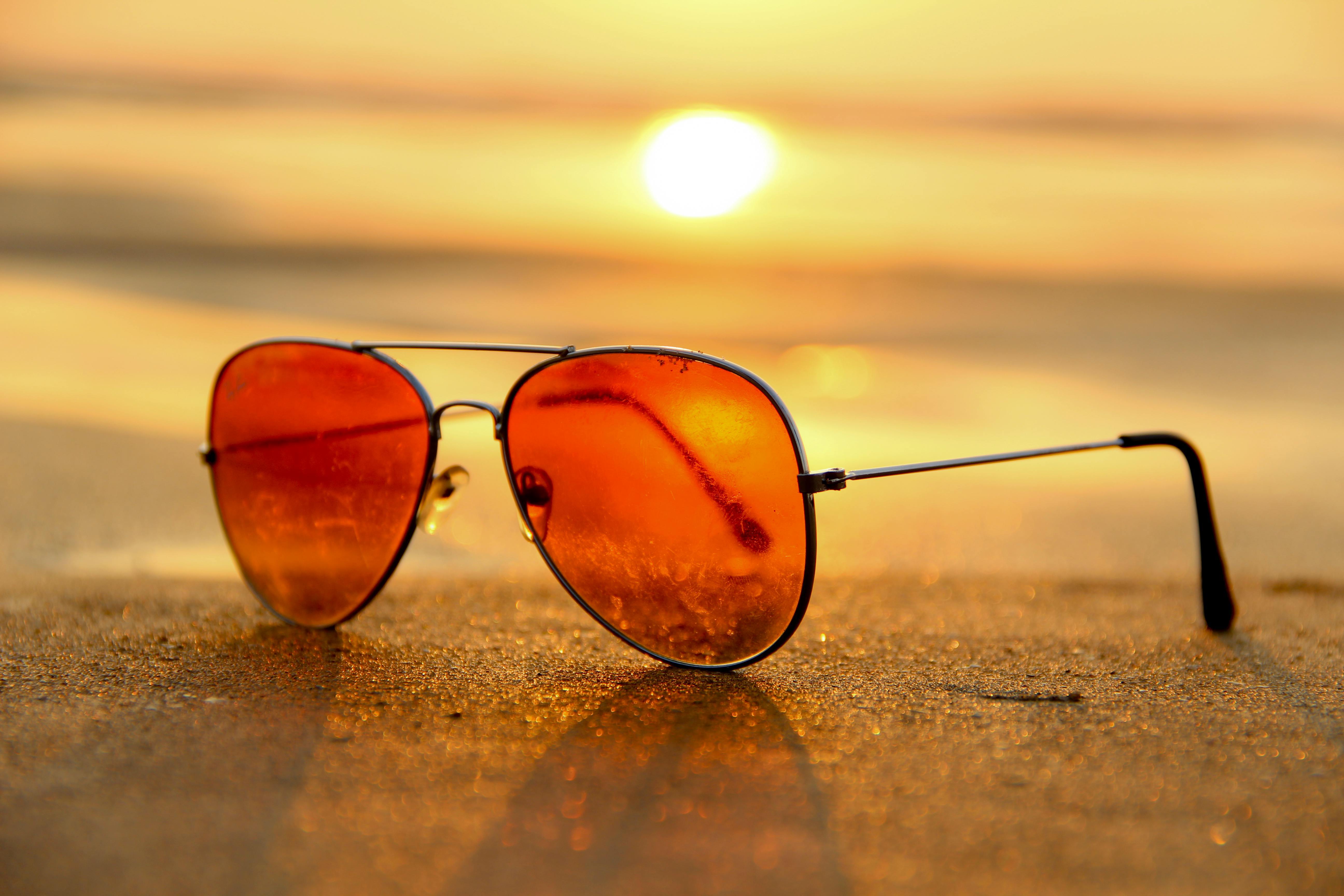A pair of sunglasses on a beach